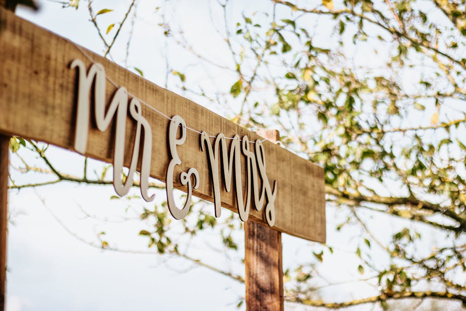 Charming 'Mr & Mrs' sign hanging outdoors on a sunny day, ideal for rustic weddings.